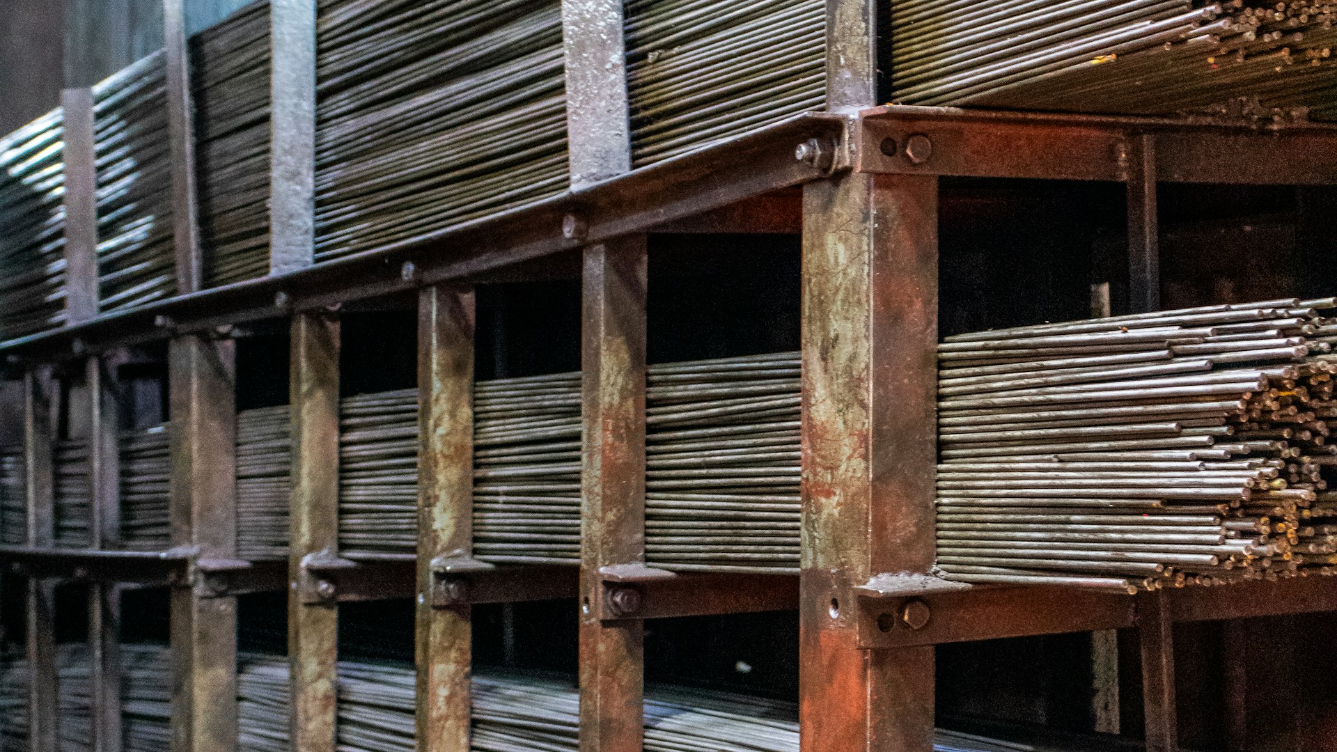 Steel tubing, wire coils and roofing sheets stacked in a wholesale supply yard